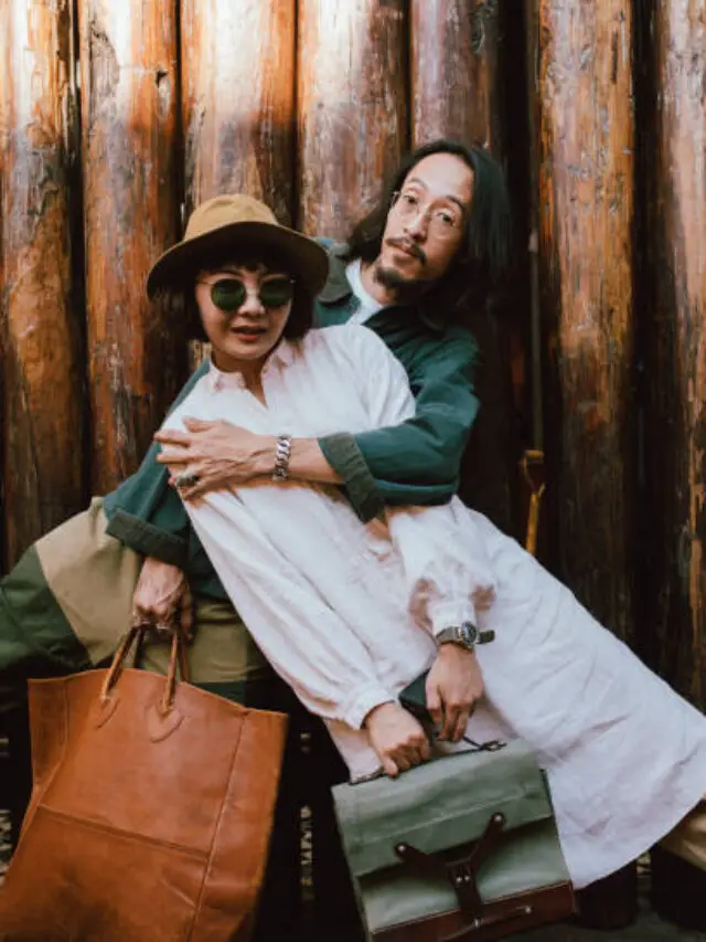 Modern romance: a young stylish Asian couple on a city street (copy space).